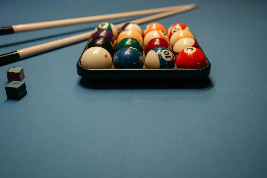 Billiard Balls and Cue Sticks on the Billiard Table