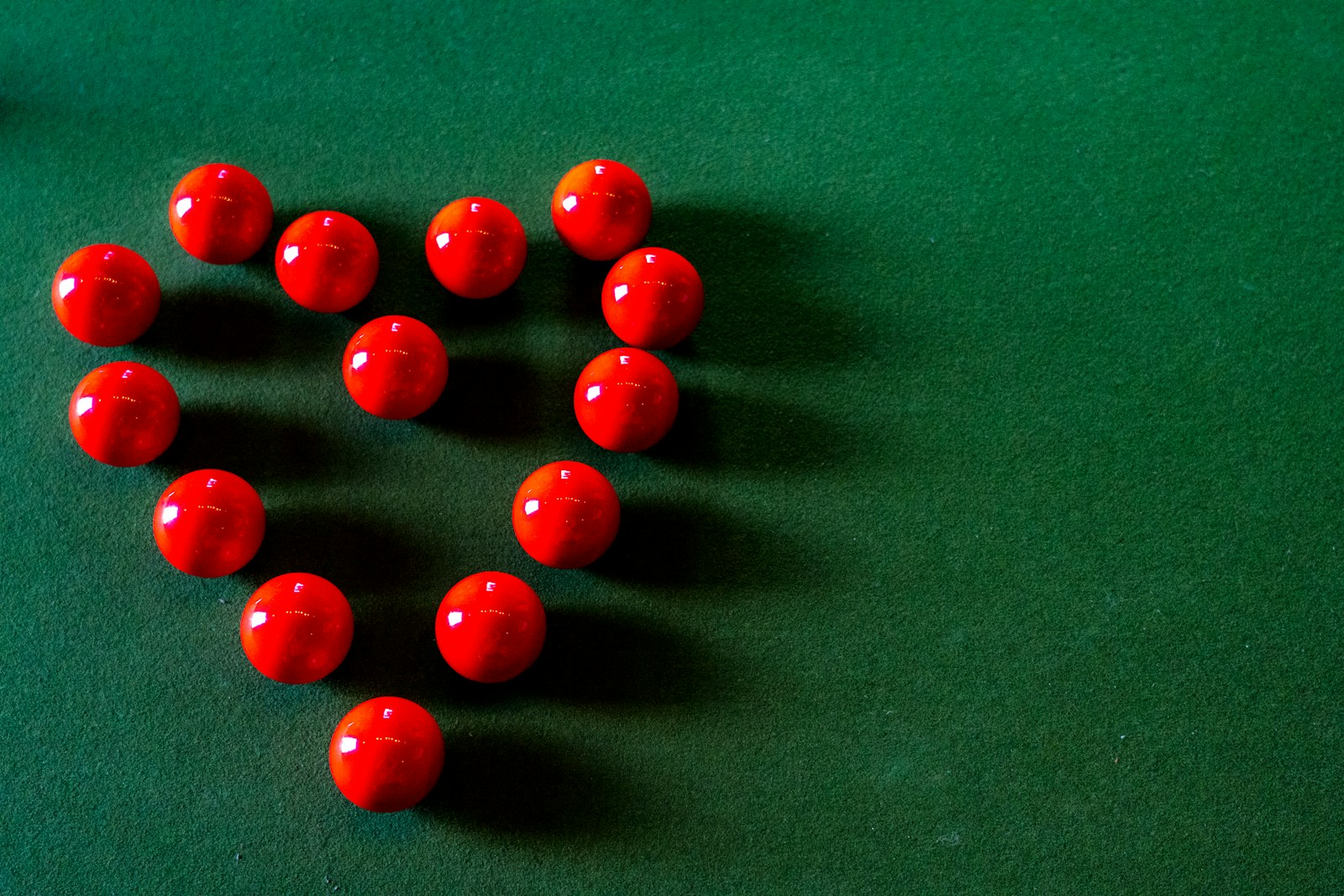 red round beads on green textile